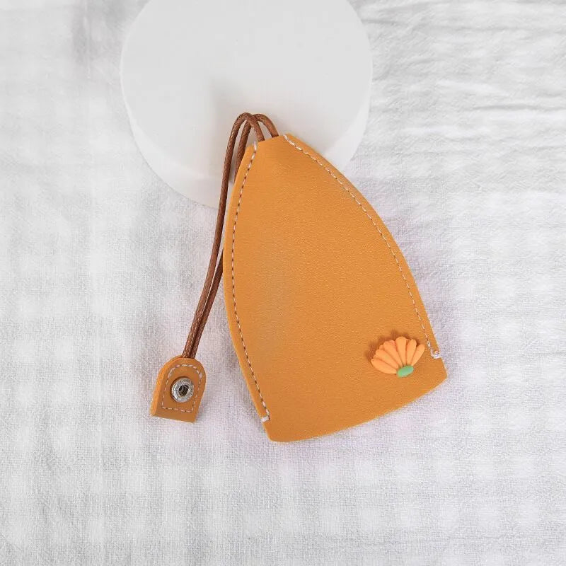 Cartoon-design PU leather pull-out key case for car keys, shown with pull tab extended.
