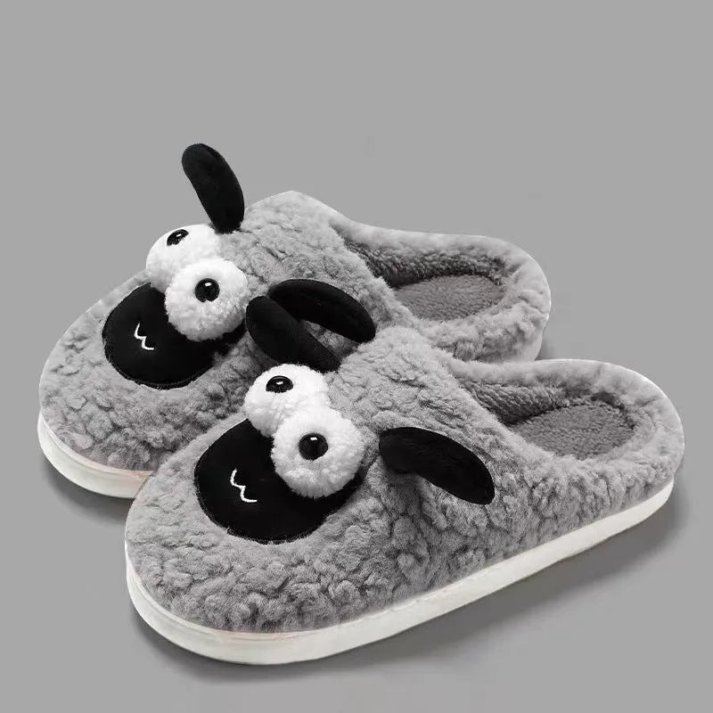 Brown suede slip-on slippers with thermal lining on a wooden floor