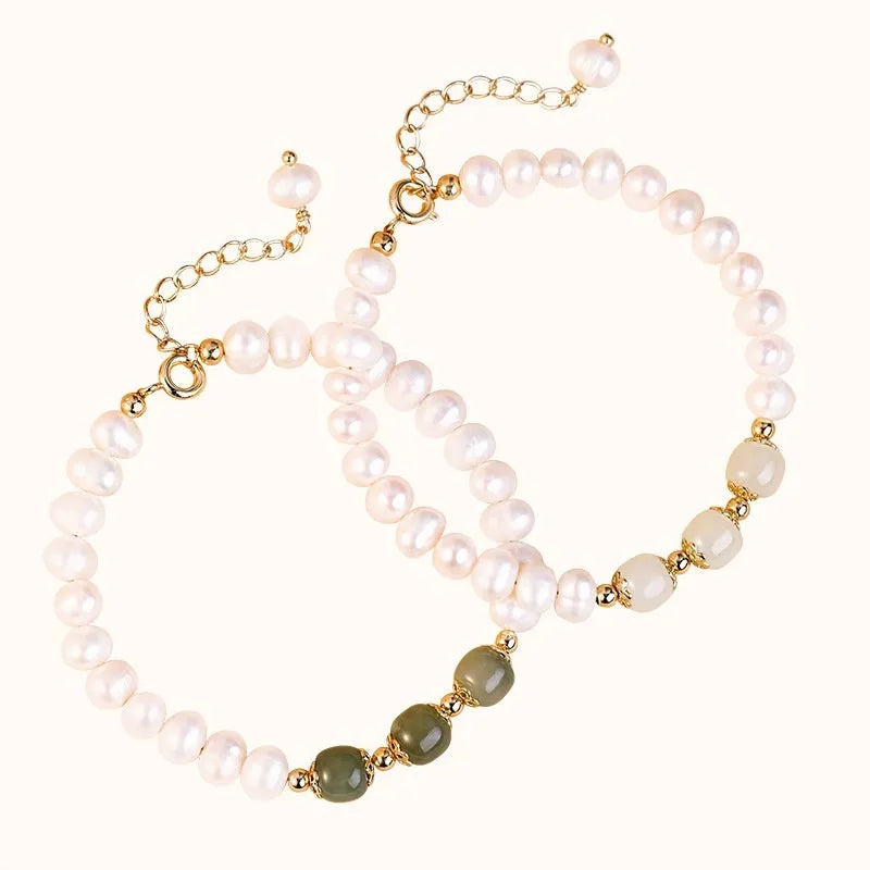 Diamond-shaped freshwater pearl bracelet in electroplated Hetian jade colour on a wrist.