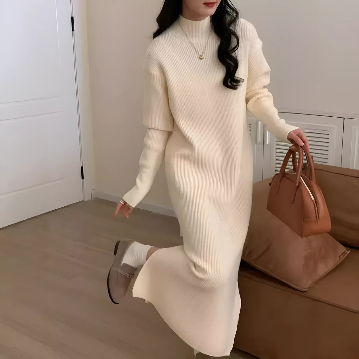 Solid colour knitted dress with half turtleneck collar and long sleeves, shown in a neutral colour.