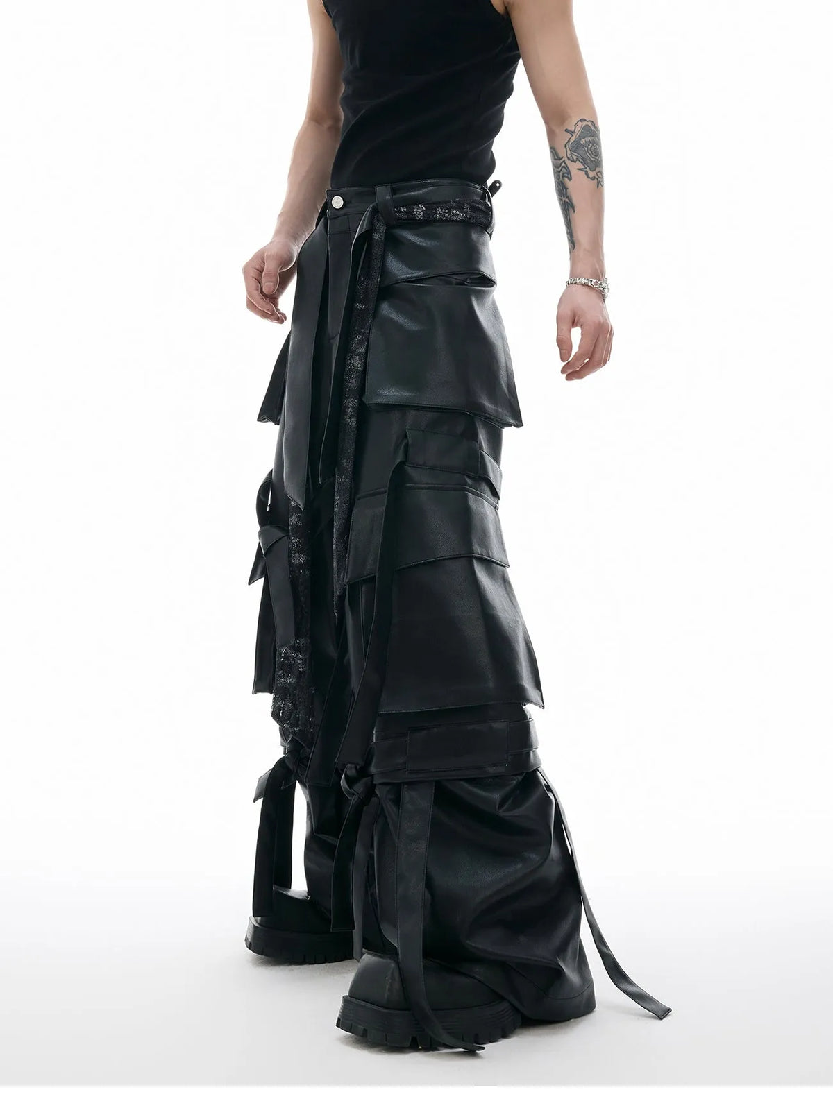 Black loose-fit men's trousers with quilted panels and multiple pockets.