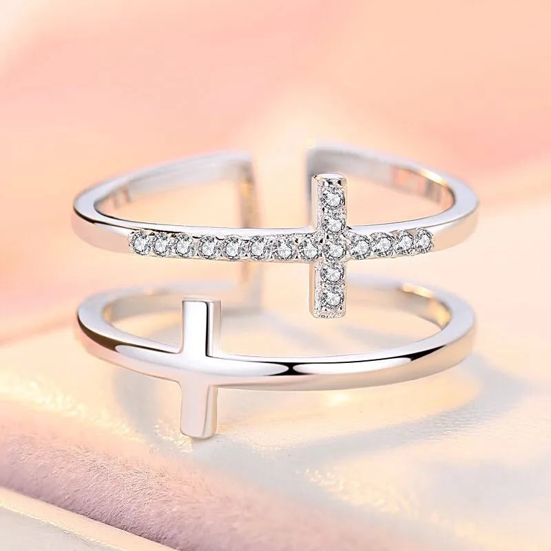 Women's adjustable double cross copper ring with zircon stones in sterling silver inlay, shown in a gold electroplated finish.