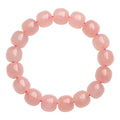 Pink natural crystal barrel bead bracelet with polished 8-10mm gemstone beads on wrist