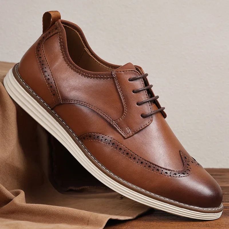 Men's black slip-on business casual shoes with round toe and carved detail on a PU upper.