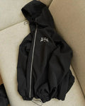 Grey men's hooded loose-fit sunscreen jacket in British style on a hanger