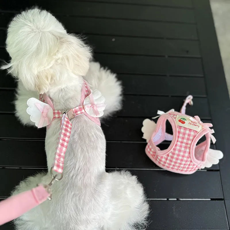 Pink cotton chest and back harness with lead for a small dog on a white background.