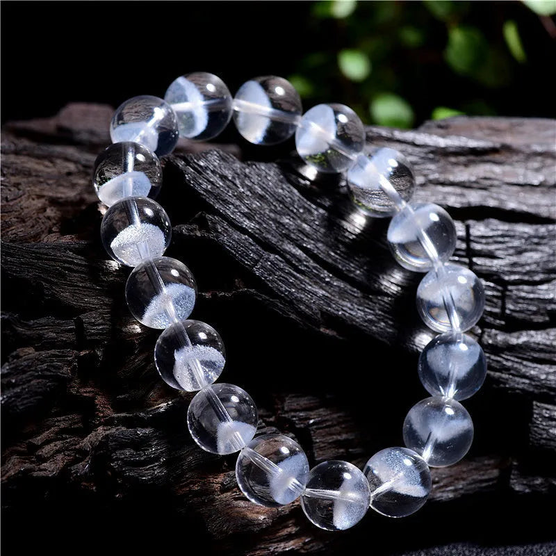 Women's natural white crystal ghost pyramid bracelet with Ruyi design on a model's wrist
