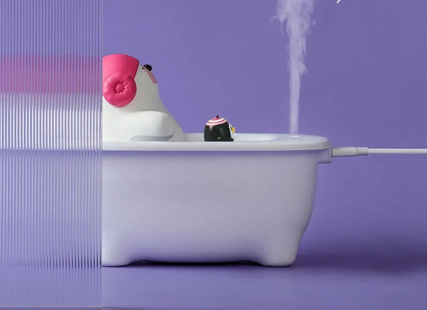 White USB air humidifier and scent diffuser with large water tank on a desk.