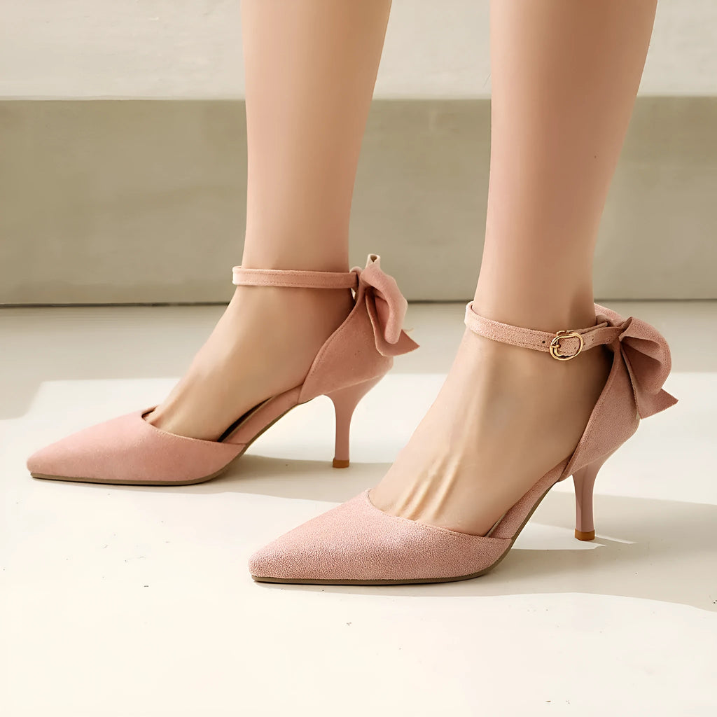 Women's black pointed-toe high heels with bowknot detail and buckle fastening