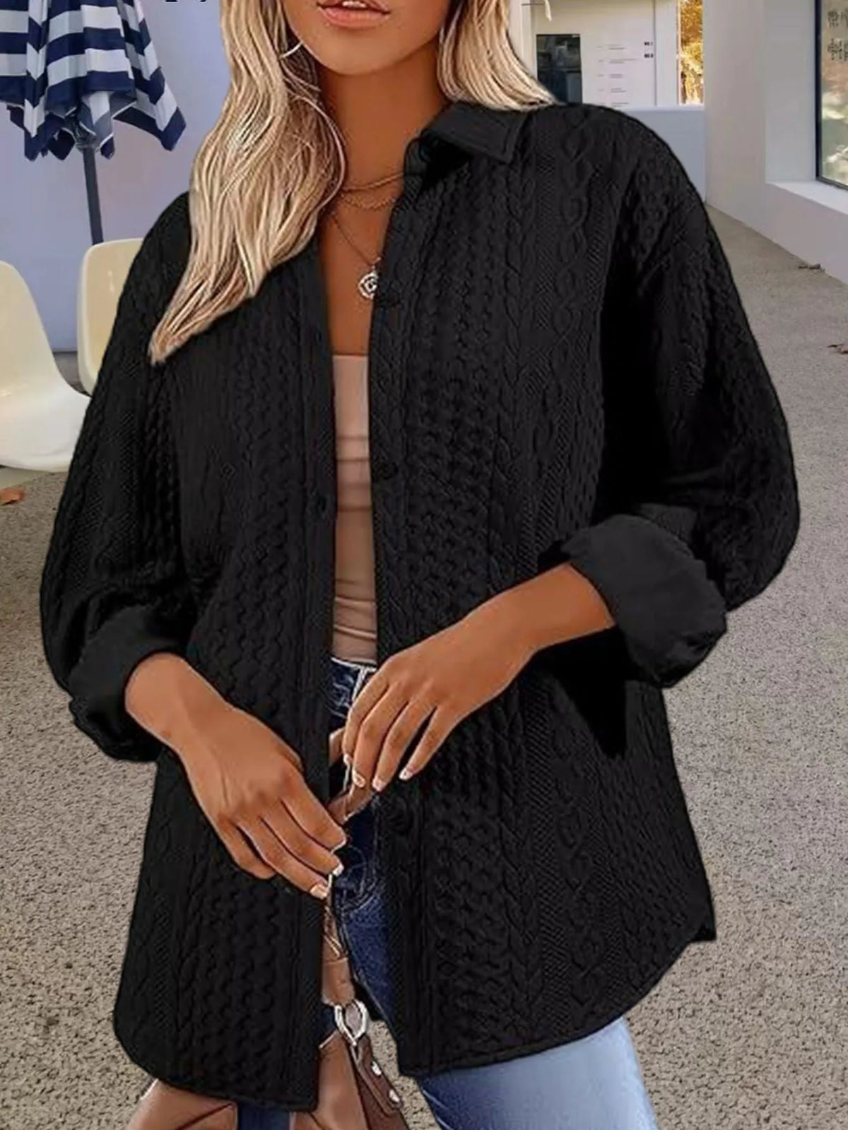 Women's solid colour knitted cardigan sweater in black, shown on a model.