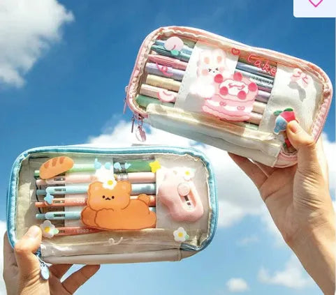 Transparent heart-shaped TPU pencil case in a pink multicolour Korean-style design with cake and rabbit motifs.