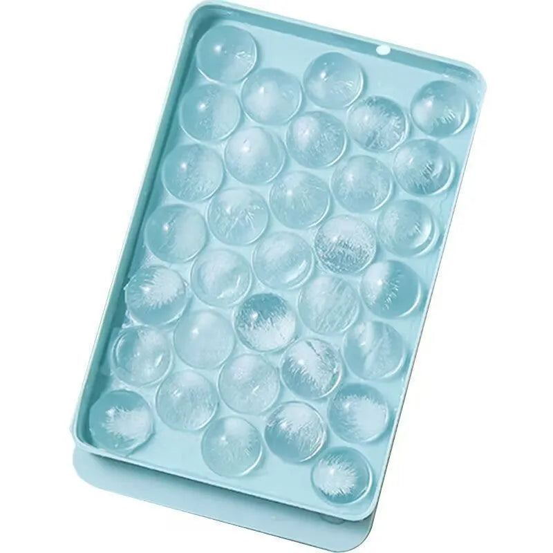 Blue silicone ice cube tray with 33 round grids and integrated lid showing 24x14x3cm dimensions