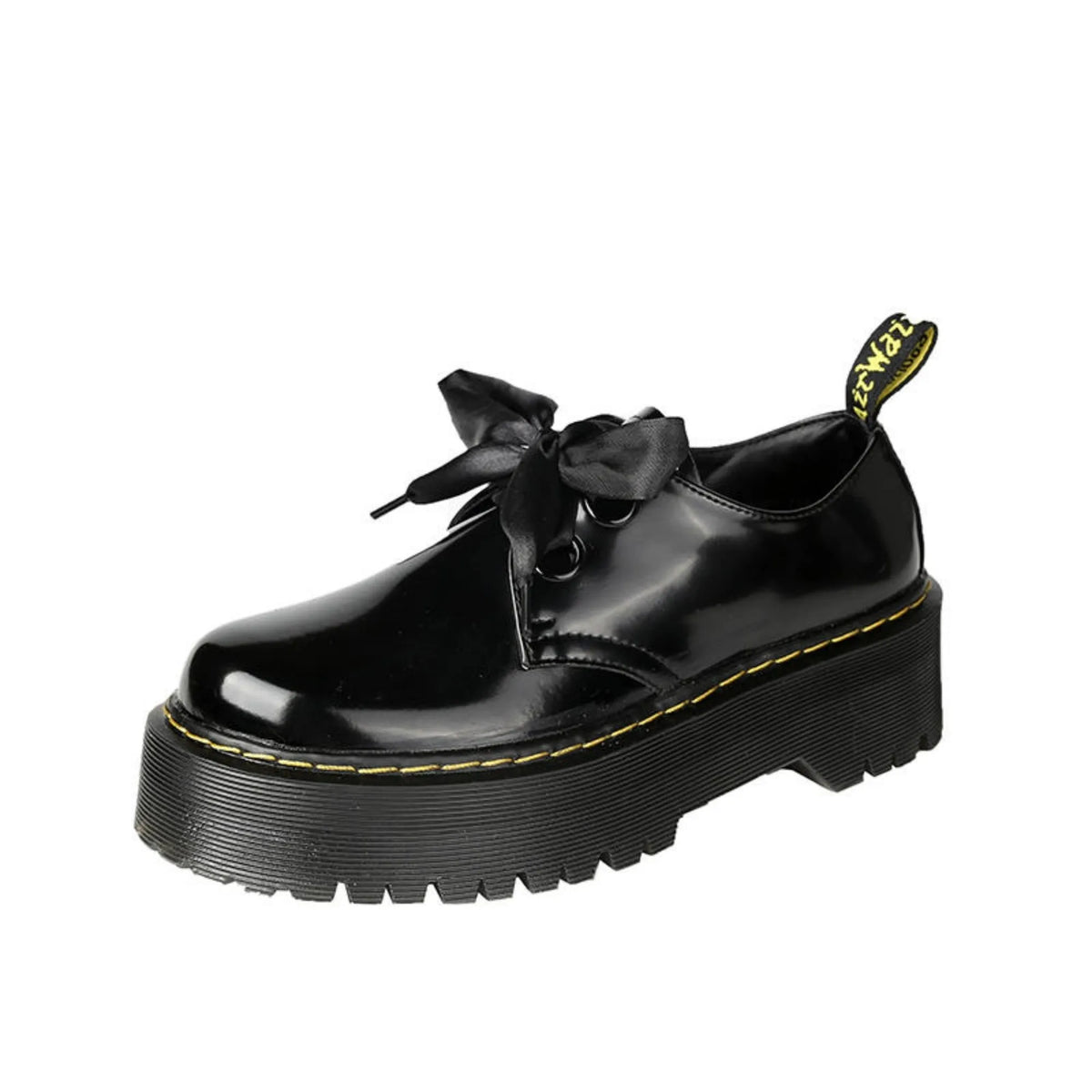 Black women's thick-soled leather lace-up shoes with a cross strap design on a white background.