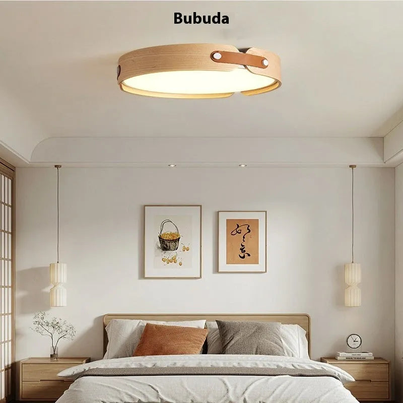 Japanese style wooden ceiling lamp with a PMMA shade in a warm light colour, shown in a bedroom setting.