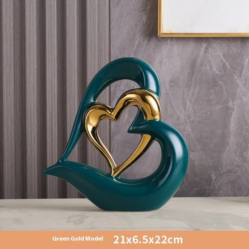 Modern geometric heart-shaped porcelain ornament in a metallic finish displayed on a cabinet.