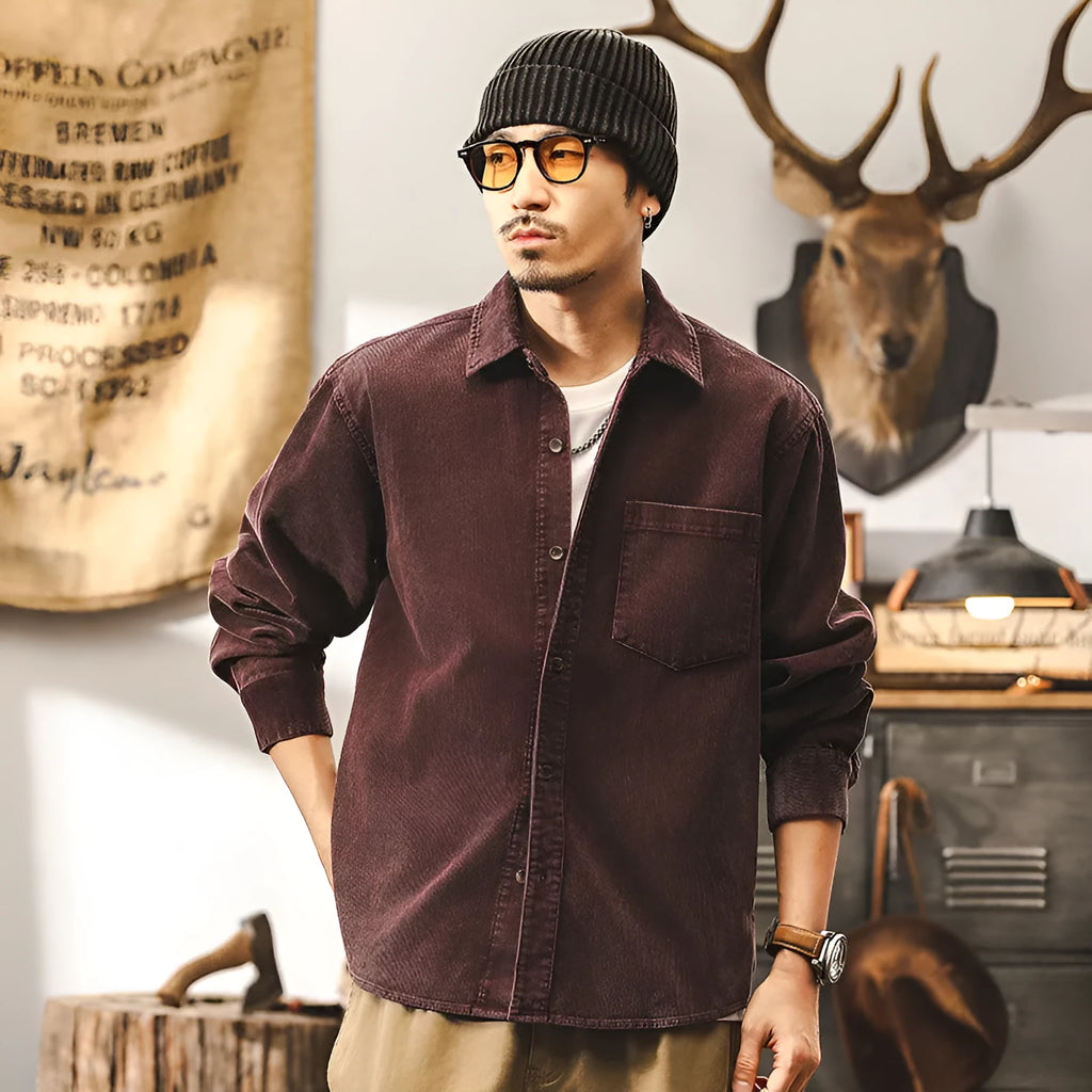 Men's loose fit corduroy shirt jacket in red or black, showing long sleeves and textured fabric.