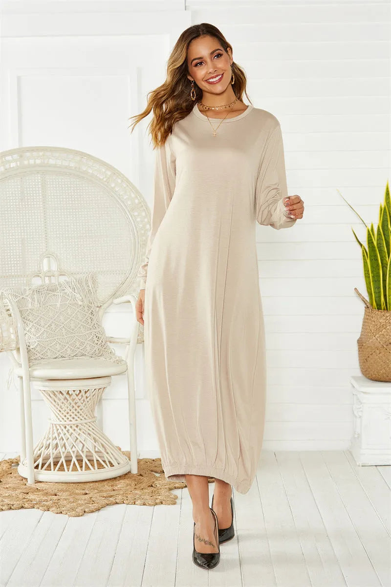A loose-fitting, long black lantern dress with a lace-up detail at the crew neck, made from knitted polyester fabric.