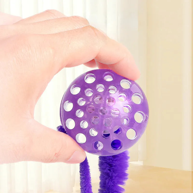 Interactive cat ball toy with bouncy TPR rubber core and removable plush tail, shown in green colour
