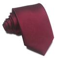 Close-up of a red and black striped men's formal tie with a jacquard weave texture.