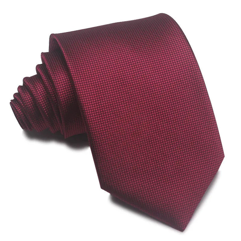 Close-up of a red and black striped men's formal tie with a jacquard weave texture.