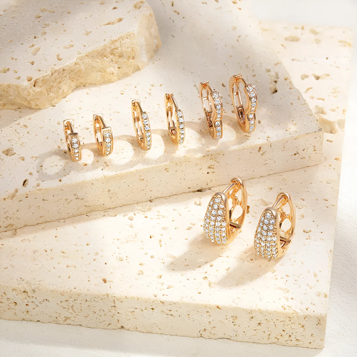 Gold plated heart-shaped clip earrings with a clear zircon stone centre.