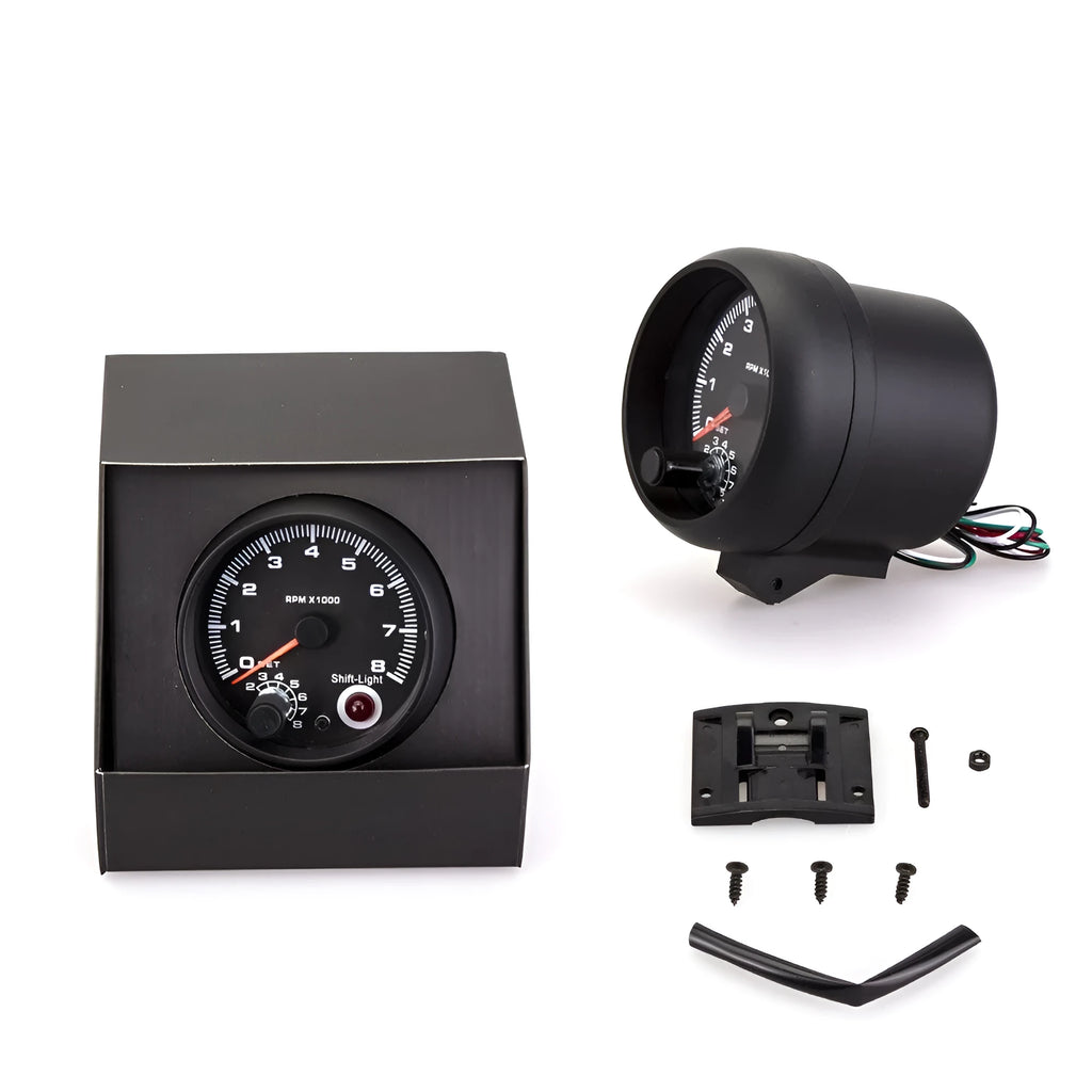 Black plastic automotive tachometer with blue indicator light for engine RPM measurement.