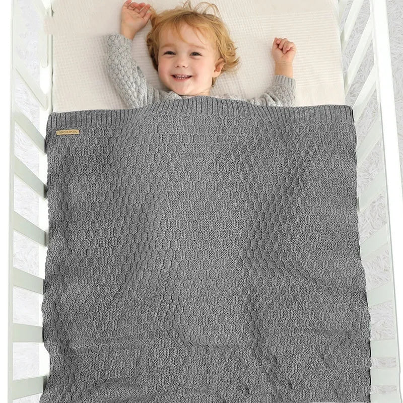 Solid colour infant hug blanket with three-dimensional lines in soft acrylic fabric, shown in light green colour