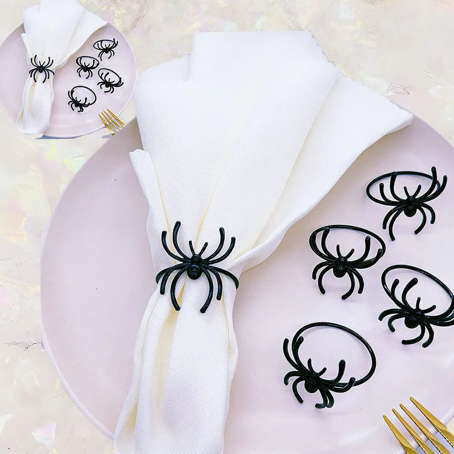 Set of six black spider patterned alloy napkin rings for Halloween table decoration